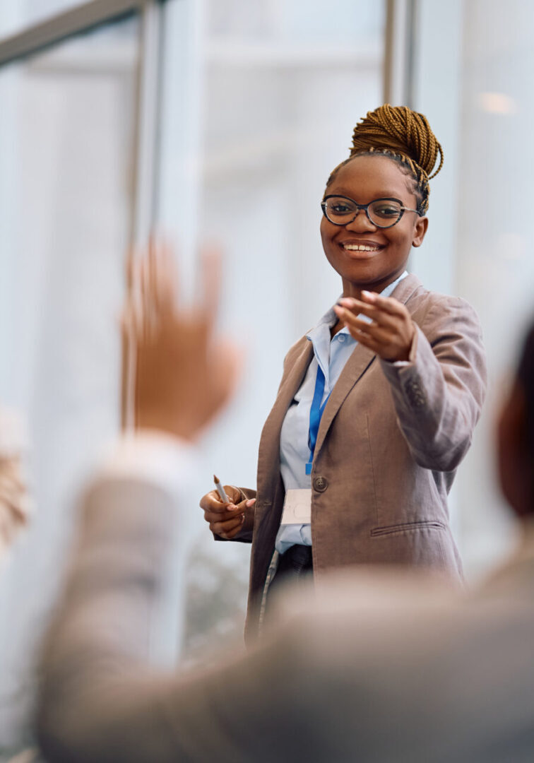 Woman presenting to engaged audience in meeting.